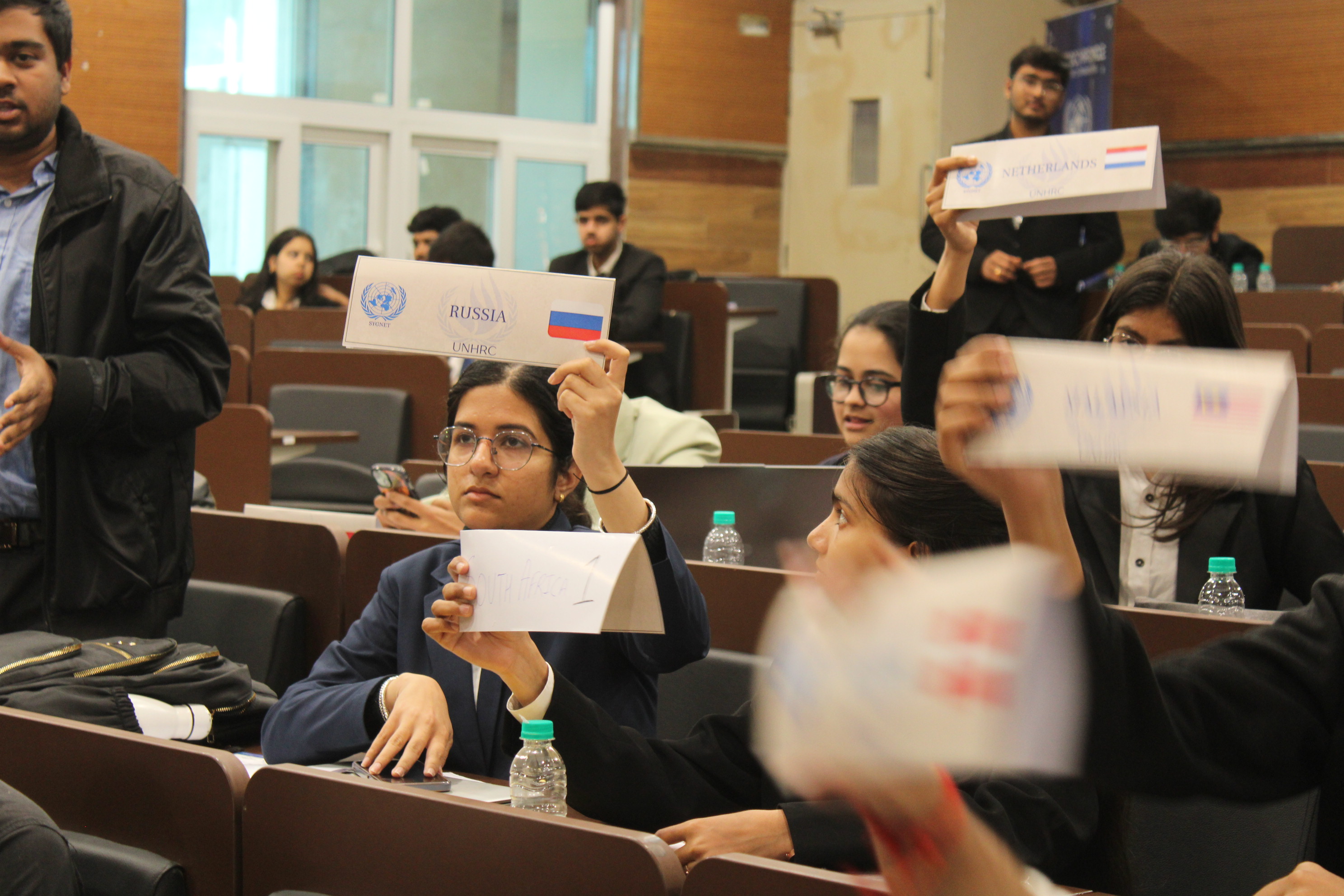 Lively voting and placard raising during session